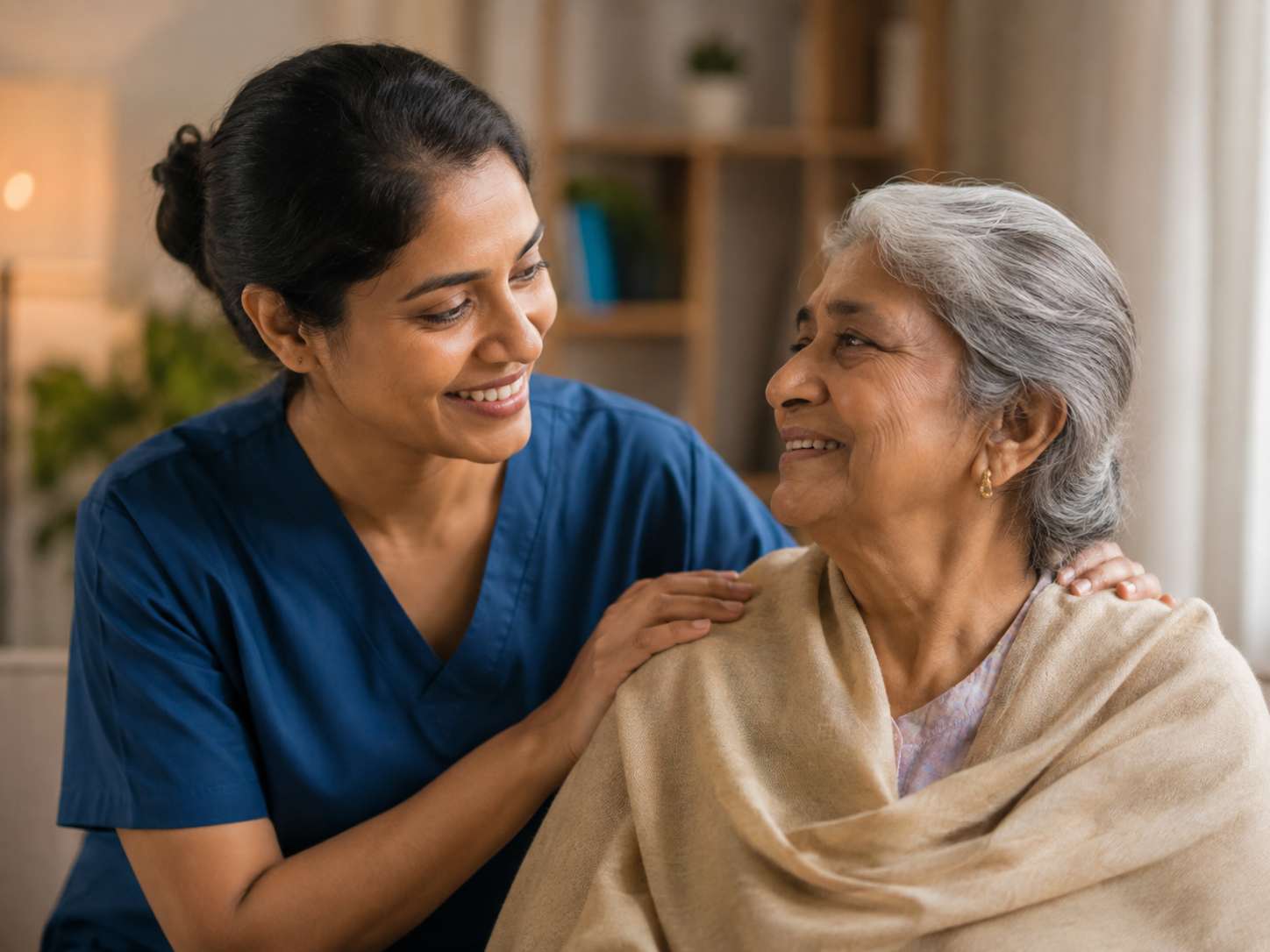 Healthcare professional smiling warmly beside an elderly woman she is caring for